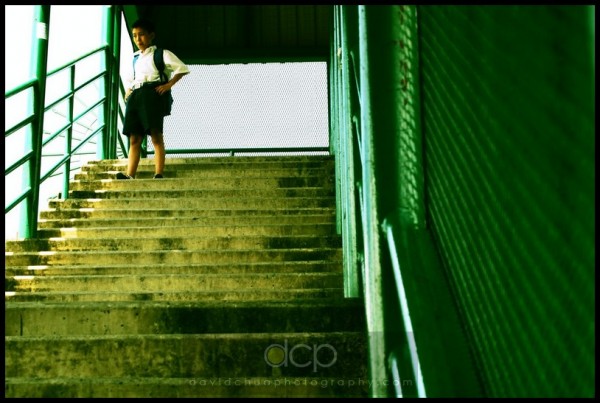 Boy waiting on staircase